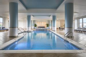 a pool in a hotel lobby with blue water at Lancaster Marriott at Penn Square in Lancaster