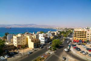 an aerial view of a city with the ocean at Yafko Hotel in Aqaba