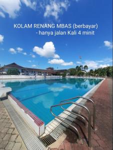 ein Pool mit einer Bank davor in der Unterkunft HOMESTAY ALORSETAR TOWNCENTRE by ASTARILA GUESTHOUSE-StadiumDarulaman - iSLAM SAHAJA - Private Pool, BBQ Zone & Kolam Pancing Puyu - 8-13pax in Alor Setar