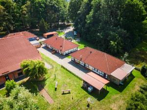 an overhead view of three buildings with red roofs at Küstenhostel in Klausdorf Mecklenburg Vorpommern