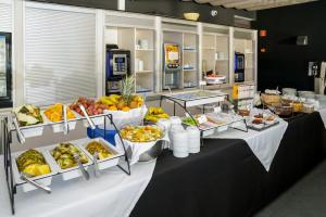 a buffet line with food and fruit on display at Carvi Beach Hotel in Lagos