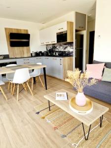a living room with a couch and a table at Le Gîte "Aubrac" Haut de gamme, Jardin, Piscine in Gabriac +34 photos
