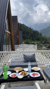 a table with plates of food on a patio at Villat Grand in Peje