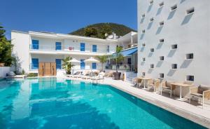 a swimming pool in front of a building at euphoria boutique hotel in Chrysi Ammoudia