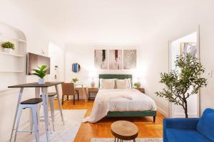 a white bedroom with a bed and a table at 105-1G Park Ave Location studio best value Sleeps3 in New York