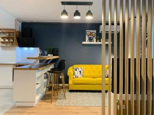 a kitchen with a yellow couch in a room at The Place 2be in Bucharest