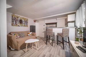 a living room with a couch and a table and chairs at Charmant DUPLEX - centre de Fontainebleau in Fontainebleau