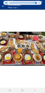 a table with eggs and other food on it at Ferme Bouhouch in Oulad Yakoub
