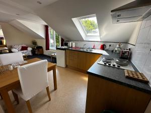 a kitchen with a stove and a table in a room at Holly Hill Apartments in Southampton