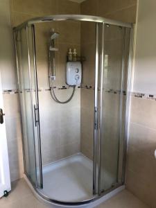 a shower with a glass door in a bathroom at Boutique En-Suite Bedroom Cork in Mallow
