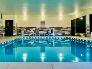 a large pool with blue water in a building at Comfort Inn & Suites Las Cruces Mesilla in Las Cruces