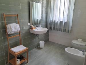 a bathroom with a sink and a toilet at B&B Da Nonna Lucia in Roccascalegna