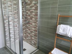 a bathroom with a shower with a glass door at B&B Da Nonna Lucia in Roccascalegna