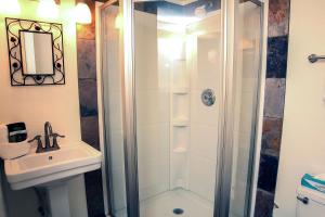 a bathroom with a shower and a sink at Timber Creek Chalets- 3 chalet in Estes Park