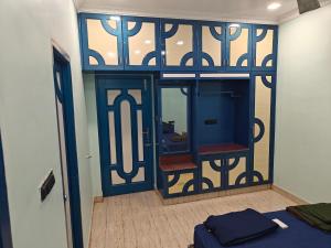 a room with a glass door with a mirror at Treva Blue Nest in Karaikal