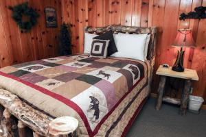 a bedroom with a bed in a log cabin at Lawn Lane A - #3382 in Estes Park