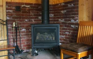a brick wall with a stove in a room at Lazy R Cottages- 1 apts in Estes Park