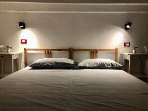 a bedroom with a large bed with two pillows at Guest House SanSiro Fiera in Milan