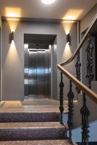 an elevator in a building with stairs and lights at APARTAMENTAI LEMBERGAS in Vilnius