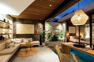 a living room with a couch and an aquarium at Danu Villas Bali in Kerobokan