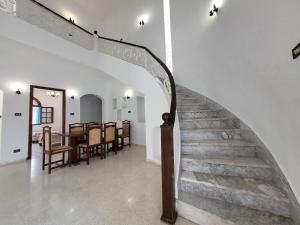 a staircase in a house with a table and chairs at Maison Karima in Djerba