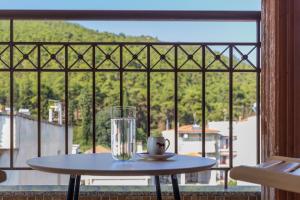 a table in front of a window with a glass at Luxury Central Apartment in Xanthi