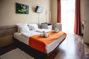 Postel nebo postele na pokoji v ubytování Hotel Kapos