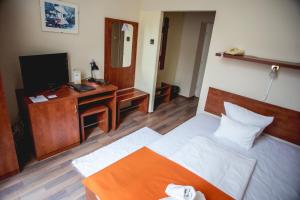 Postel nebo postele na pokoji v ubytování Hotel Kapos