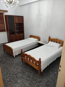 two beds sitting in a room with at Lemon Apartment near to Pireaus Port in Piraeus