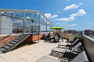 a balcony with stairs and tables and chairs on a building at Modern & Charming Apt With Rooftop @pentagon City in Arlington