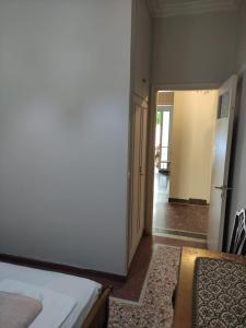 a room with a bed and a door to a hallway at Lemon Apartment near to Pireaus Port in Piraeus