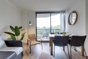 a living room with a table and chairs with a view at Modern & Charming Apt With Rooftop @pentagon City in Arlington