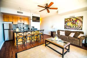 a living room and kitchen with a couch and a table at Water Street Retreat 12 in Wilmington +25 photos