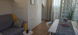 a living room with a couch and a table at Apartman Campo in Šibenik