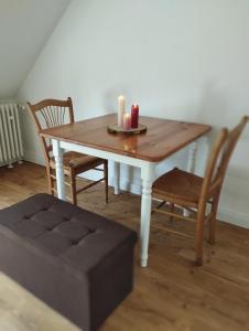 a table with two candles on it with two chairs at Apartment Wittorf in Neumünster