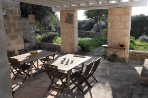 a patio with a table and chairs on a patio at FINCA SON SEGUI in Alaior