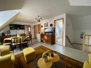 a living room with a kitchen and a dining room at Varga Apartman in Balatonberény