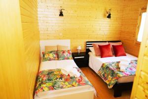 two beds in a room with wooden walls at Villa Ramiro in Celorico de Basto +113 photos