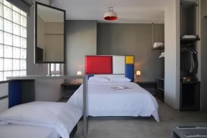a bedroom with a bed with a tv on it at Design Architectonika in Skiathos Town