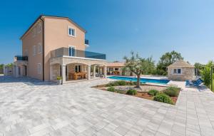 a villa with a swimming pool and a house at Stone Luxury Villa in Gajana