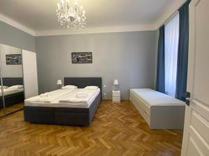 a bedroom with two beds and a chandelier at Top class apartments in Carlsbad Bulharska street in Karlovy Vary