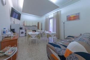 a living room with two beds and a kitchen at Affittacamere SS. Smile in Loreto