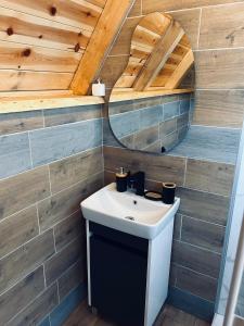 a bathroom with a sink and a mirror at Nomad Lodge Zminica in Žabljak +29 photos