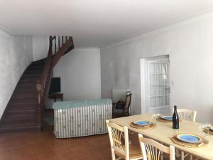 ein Esszimmer mit einem Tisch und einer Treppe in der Unterkunft La casa Marcel, maison de 110 m2 in 