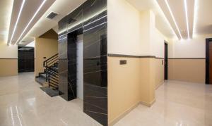 un pasillo con baldosas negras y escaleras en un edificio en Treebo Trend The Armani, en Nueva Delhi