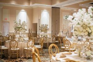 een feestzaal met tafels, stoelen en bloemen bij Crowne Plaza Executive Center Baton Rouge, an IHG Hotel in Baton Rouge