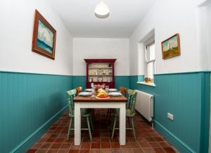 a dining room with a table and chairs at St John's Point Lightkeeper's Houses, Donegal in St John's Point