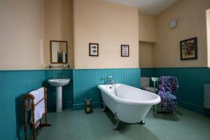 a bathroom with a tub and a sink at St John's Point Lightkeeper's Houses, Donegal in St John's Point