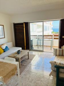 a living room with a couch and a table at Denia Apartamento a 20m de la Playa in Denia