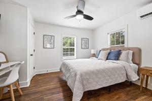 a bedroom with a bed and a ceiling fan at Charming Saints Street Cottage in Lafayette